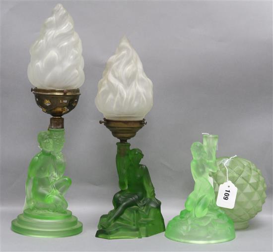 A frosted green glass figural lamp base, possibly by Schweig, Muller & Co,  two similar lamp bases and three shades,